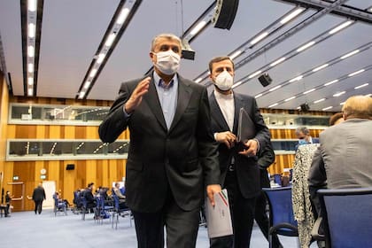 ARCHIVO - Mohammad Eslami, nuevo responsable de la agencia nuclear iraní (AEOI), a la izquierda, y el gobernador de Irán ante el Organismo Internacional de la Energía Atómica (OIEA), Kazem Gharib Abadi, salen de la Conferencia General del OIEA en Viena, Australia, el lunes 20 de septiembre de 2021.  (AP Foto/Lisa Leutner, Archivo)