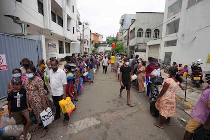 Decenas de personas hacen cola para comprar querosene en Colombo, Sri Lanka, el 12 de abril del 2022. El aumento en las tasas de interés de EEUU repercute en todo el mundo y golpea con más fuerza a las economías vulnerables de países en desarrollo como Sri Lanka, que hace poco suspendió el pago de su deuda. (AP Photo/Eranga Jayawardena, File)