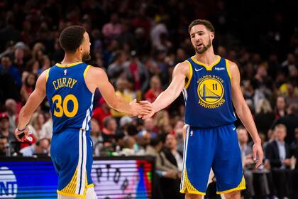 Golden State Warriors guard Klay Thompson (11) congratulates guard Stephen Curry (30) during the second half against the Portland Trail Blazers in game three of the Western conference finals of the 2019 NBA Playoffs at Moda Center. The Golden State Warriors beat the Portland Trail Blazers 110-99