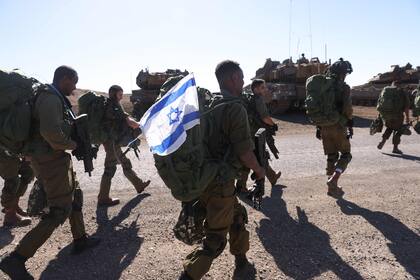 Israeli soldiers walk during a drill in the annexed Golan Heights on November 9, 2023, amid increasing cross-border tensions between Hezbollah and Israel as fighting continues in the south with Hamas militants in the Gaza Strip. (Photo by Jalaa MAREY / AFP)�