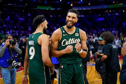 Jayson Tatum (derecha) y Derrick White, de los Celtics de Boston, festejan la victoria sobre los 76ers de Filadelfia, el sábado 25 de febrero de 2023 (AP Foto/Matt Slocum)