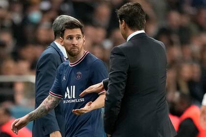 Lionel Messi observa al técnico el PSG Mauricio Pochettino tras ser sustituido en el partido contra Lyon por la liga de Francia