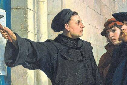 Lutero pegando sus tesis en la pared de la iglesia de Wittenberg